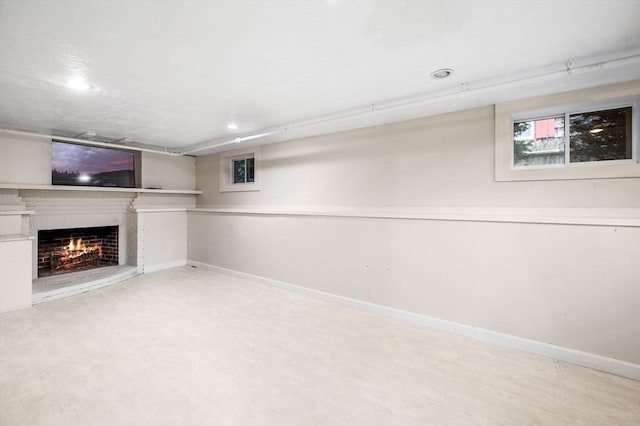 42 Pickwick Rd, Marblehead, MA 01945 - basement featuring a lit fireplace, recessed lighting, and baseboards