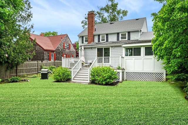 42 Pickwick Rd, Marblehead, MA 01945 - back of property featuring a chimney, a wooden deck, and roof with shingles