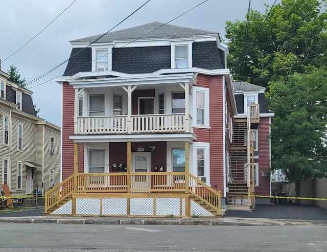 68 Temple St, Haverhill, MA 01832 - victorian home with a shingled roof, stairs, a balcony, and covered porch