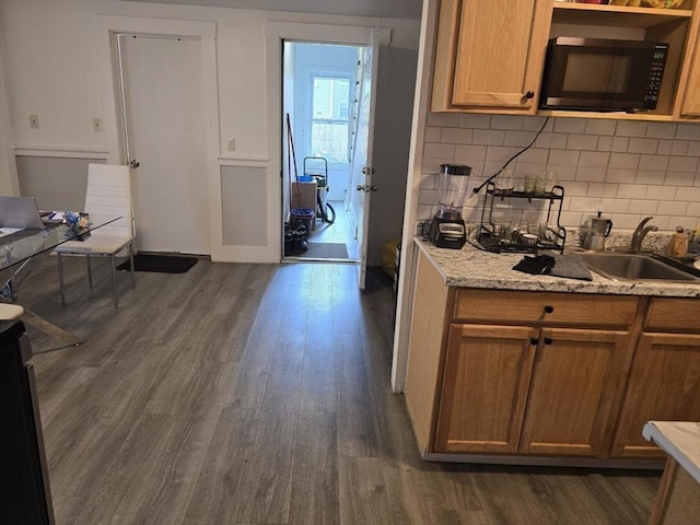 68 Temple St, Haverhill, MA 01832 - kitchen featuring black microwave, dark wood-style flooring, tasteful backsplash, and brown cabinets