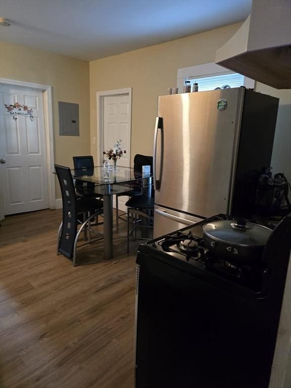 68 Temple St, Haverhill, MA 01832 - kitchen featuring range, freestanding refrigerator, electric panel, and wood finished floors