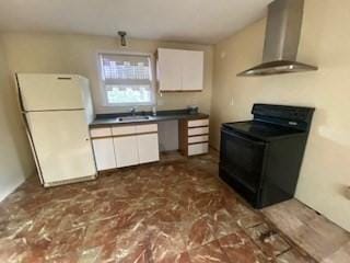 kitchen featuring freestanding refrigerator, black electric range, white cabinetry, dark countertops, and wall chimney range hood