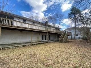 back of property featuring a wooden deck and stairs