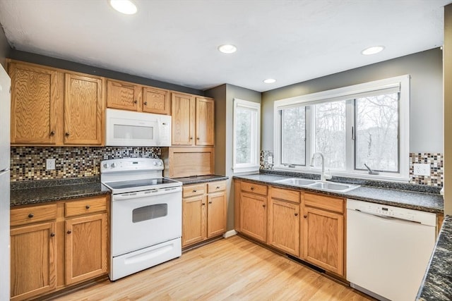 105 Edgewater Dr W, Falmouth, MA 02536 - kitchen featuring a sink, light wood-type flooring, decorative backsplash, white appliances, and brown cabinetry
