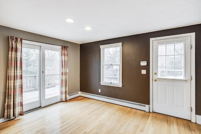 105 Edgewater Dr W, Falmouth, MA 02536 - doorway with a baseboard heating unit, a healthy amount of sunlight, and light wood-type flooring