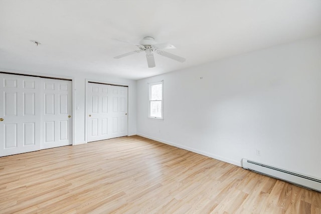 105 Edgewater Dr W, Falmouth, MA 02536 - unfurnished bedroom with a baseboard heating unit, baseboards, light wood-style floors, ceiling fan, and multiple closets