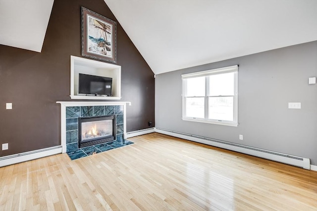 105 Edgewater Dr W, Falmouth, MA 02536 - unfurnished living room with baseboards, wood finished floors, a tile fireplace, high vaulted ceiling, and a baseboard radiator