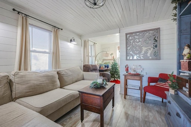 living room with wood walls and light wood-type flooring