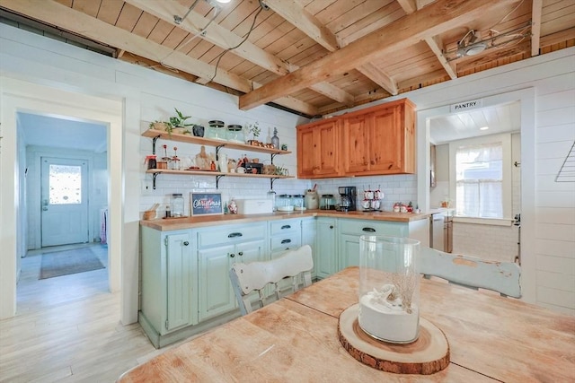 kitchen with plenty of natural light, beam ceiling, wooden ceiling, and tasteful backsplash