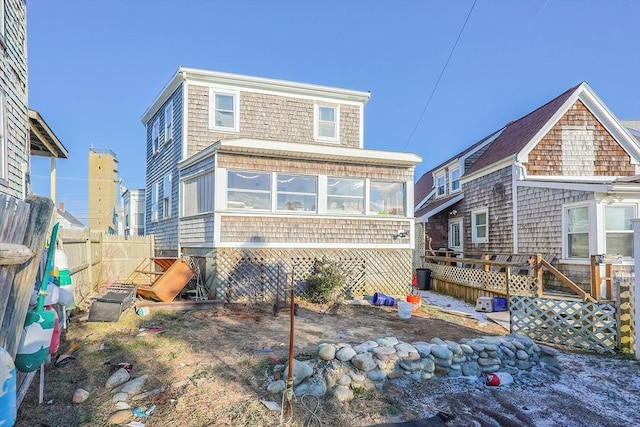 rear view of property featuring a sunroom