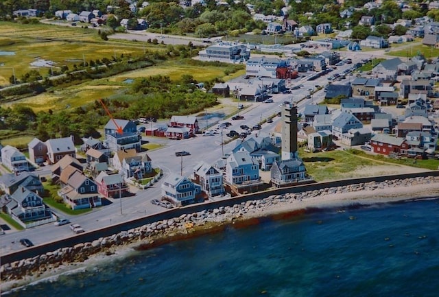 birds eye view of property with a water view and a view of the beach