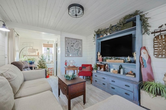 living room featuring wood walls, light hardwood / wood-style flooring, and wood ceiling