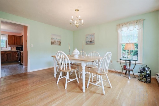 119 Messenger St, Plainville, MA 02762 - dining room featuring a chandelier, light wood-type flooring, and baseboards