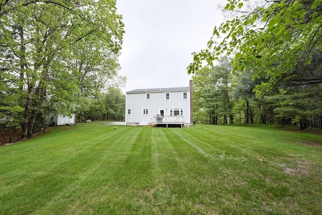 119 Messenger St, Plainville, MA 02762 - rear view of house featuring a chimney, a yard, and a deck