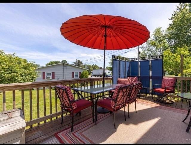 16 Howard Ave, Wells, ME 04090 - wooden terrace with outdoor dining space and a lawn