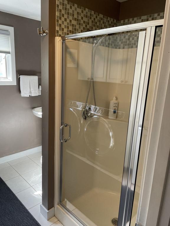16 Howard Ave, Wells, ME 04090 - full bathroom with tile patterned floors, a shower stall, and baseboards