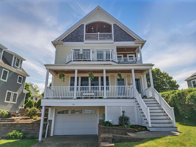 96 Sea Ave, Quincy, MA 02169 - beach home featuring a balcony, a porch, a garage, stairs, and decorative driveway