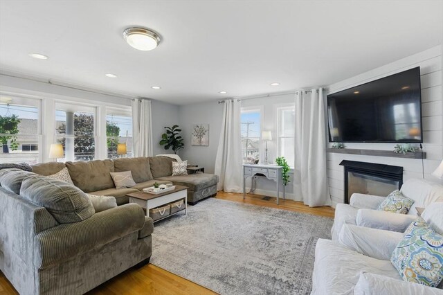 96 Sea Ave, Quincy, MA 02169 - living area with plenty of natural light, a fireplace, wood finished floors, and recessed lighting