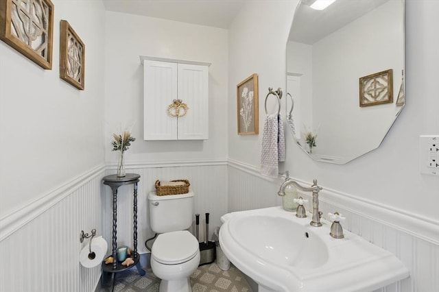 96 Sea Ave, Quincy, MA 02169 - half bathroom featuring wainscoting, toilet, a sink, and a decorative wall