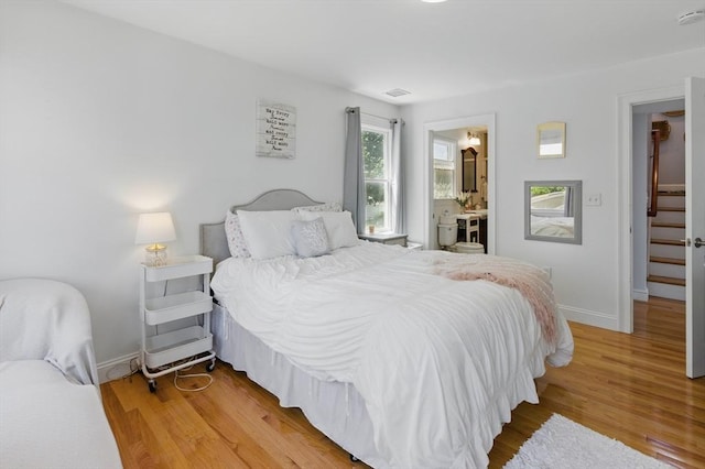 96 Sea Ave, Quincy, MA 02169 - bedroom featuring light wood-style floors, baseboards, and connected bathroom
