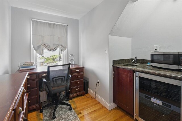 96 Sea Ave, Quincy, MA 02169 - home office featuring beverage cooler, a sink, light wood-style flooring, and baseboards