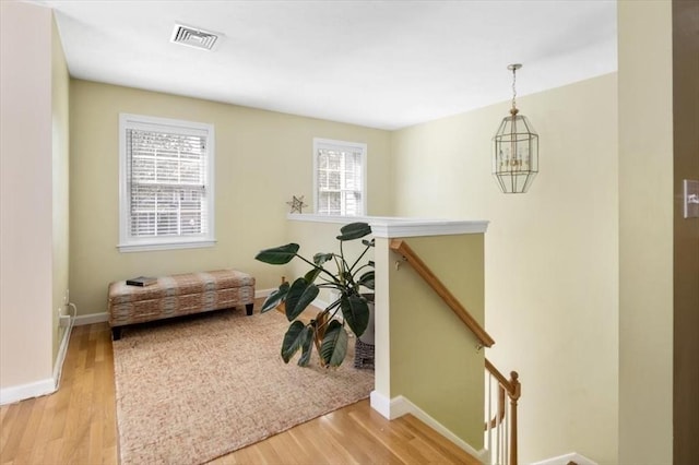 interior space featuring baseboards, visible vents, and wood finished floors