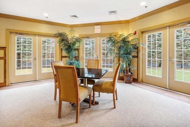 dining space with carpet floors, a wealth of natural light, french doors, and visible vents
