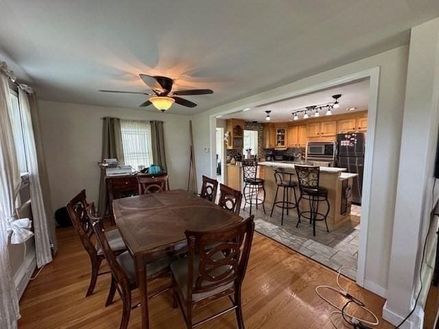 dining room featuring ceiling fan and light wood-type flooring