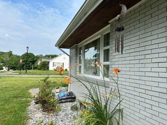 view of home's exterior with a lawn