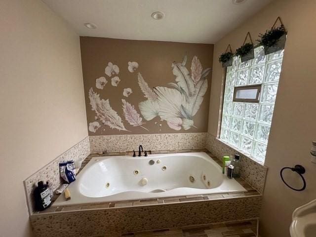 bathroom featuring a relaxing tiled tub