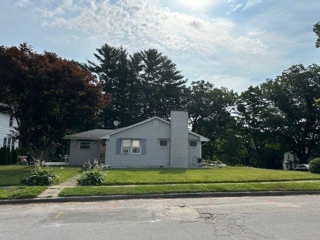 view of side of property with a yard