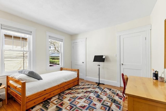 bedroom with baseboards and light wood-style flooring