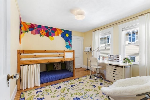 bedroom featuring baseboards and wood finished floors