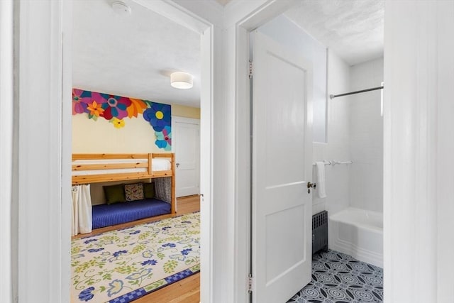 full bathroom with tile patterned floors, radiator heating unit, and bathtub / shower combination