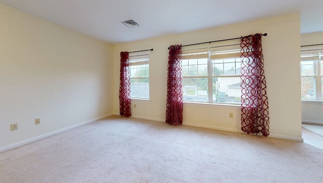 spare room with light colored carpet