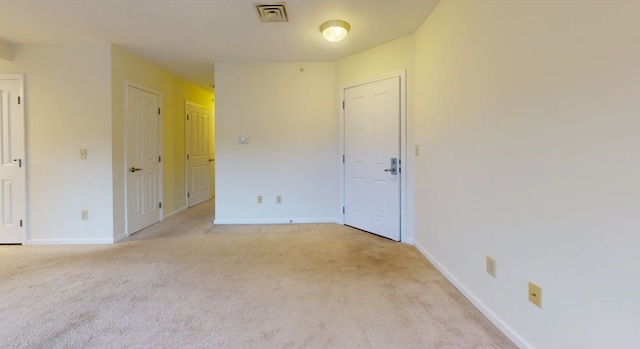 empty room featuring light carpet