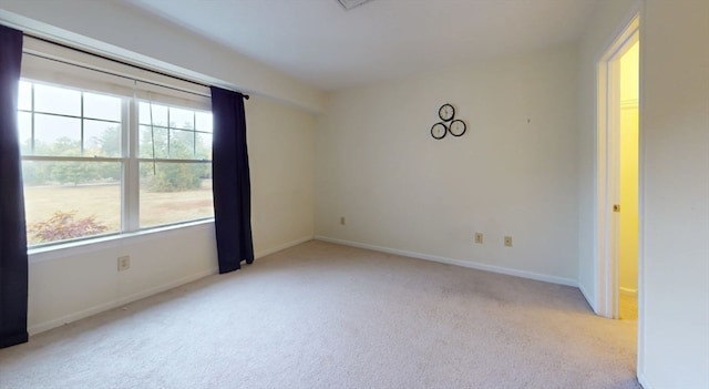 spare room with light colored carpet