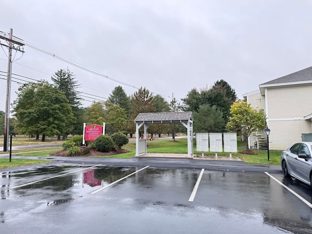 view of parking / parking lot with a mail area