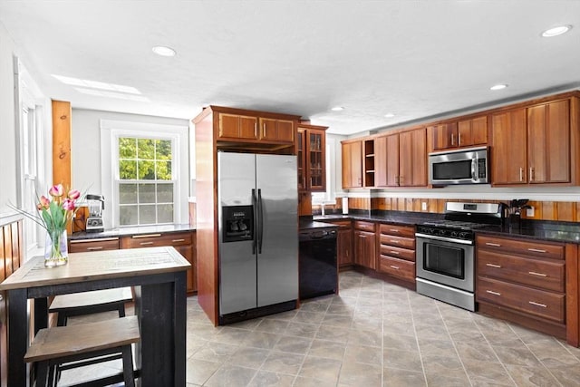553 Center St, Hanover, MA 02339 - kitchen featuring stainless steel appliances, recessed lighting, glass insert cabinets, and brown cabinetry