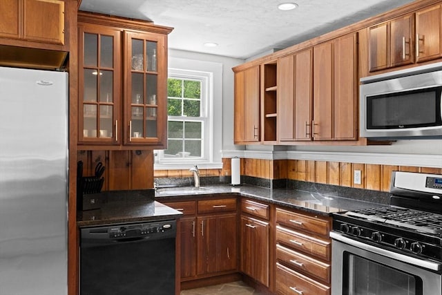 553 Center St, Hanover, MA 02339 - kitchen with appliances with stainless steel finishes, open shelves, dark stone countertops, glass insert cabinets, and recessed lighting