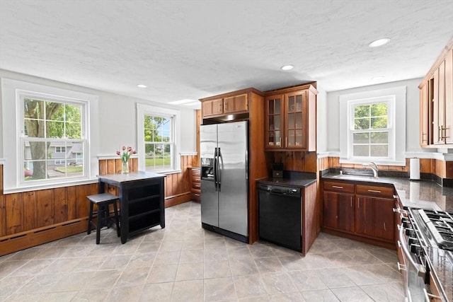 553 Center St, Hanover, MA 02339 - kitchen featuring appliances with stainless steel finishes, glass insert cabinets, recessed lighting, wainscoting, and dark countertops