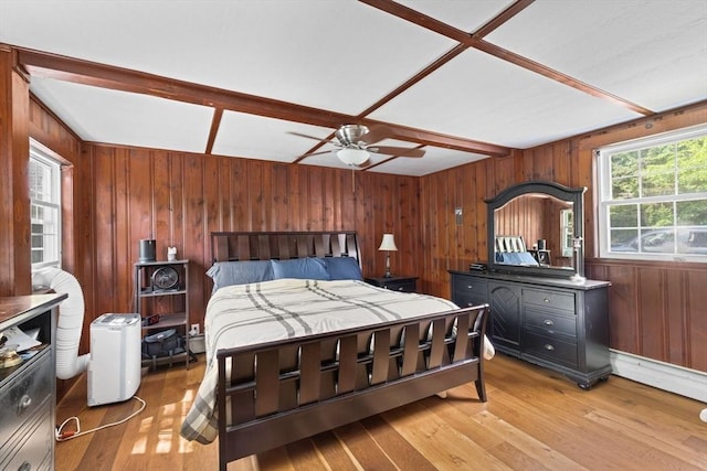 553 Center St, Hanover, MA 02339 - bedroom with wooden walls, light wood-style floors, a baseboard heating unit, and ceiling fan