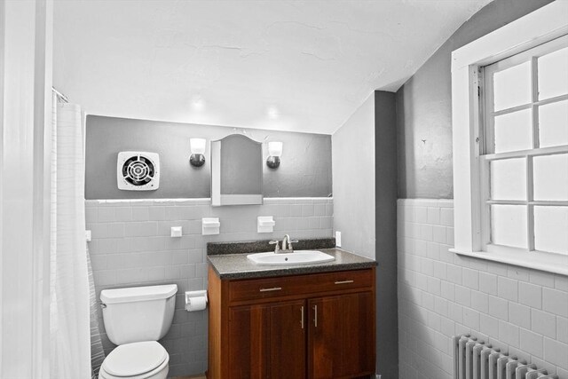 553 Center St, Hanover, MA 02339 - bathroom with tile walls, radiator, vanity, wainscoting, and a shower with shower curtain