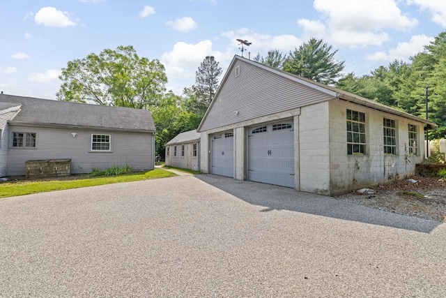 553 Center St, Hanover, MA 02339 - view of side of home featuring a garage and concrete block siding