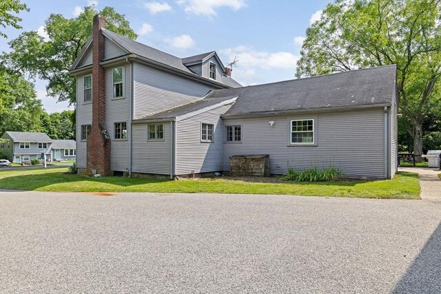 553 Center St, Hanover, MA 02339 - view of side of home featuring a chimney, a lawn, and roof with shingles