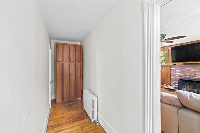 553 Center St, Hanover, MA 02339 - corridor featuring radiator heating unit and light wood-style floors