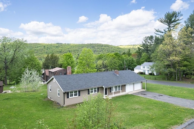 3 Bayberry Ln, Westfield, MA 01085 - single story home with a front yard, a chimney, and a view of trees