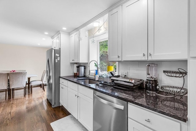 3 Bayberry Ln, Westfield, MA 01085 - kitchen with stainless steel appliances, a sink, dark wood-style flooring, dark stone countertops, and white cabinetry