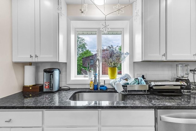 3 Bayberry Ln, Westfield, MA 01085 - kitchen featuring a sink, white cabinetry, a chandelier, dark stone counters, and tasteful backsplash