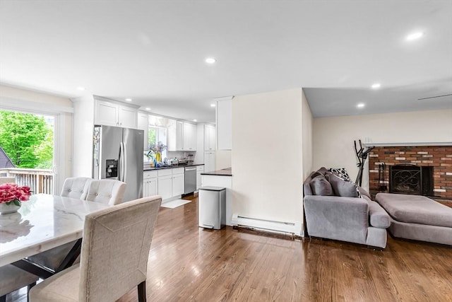 3 Bayberry Ln, Westfield, MA 01085 - dining area with a baseboard heating unit, dark wood-style floors, healthy amount of natural light, recessed lighting, and a fireplace